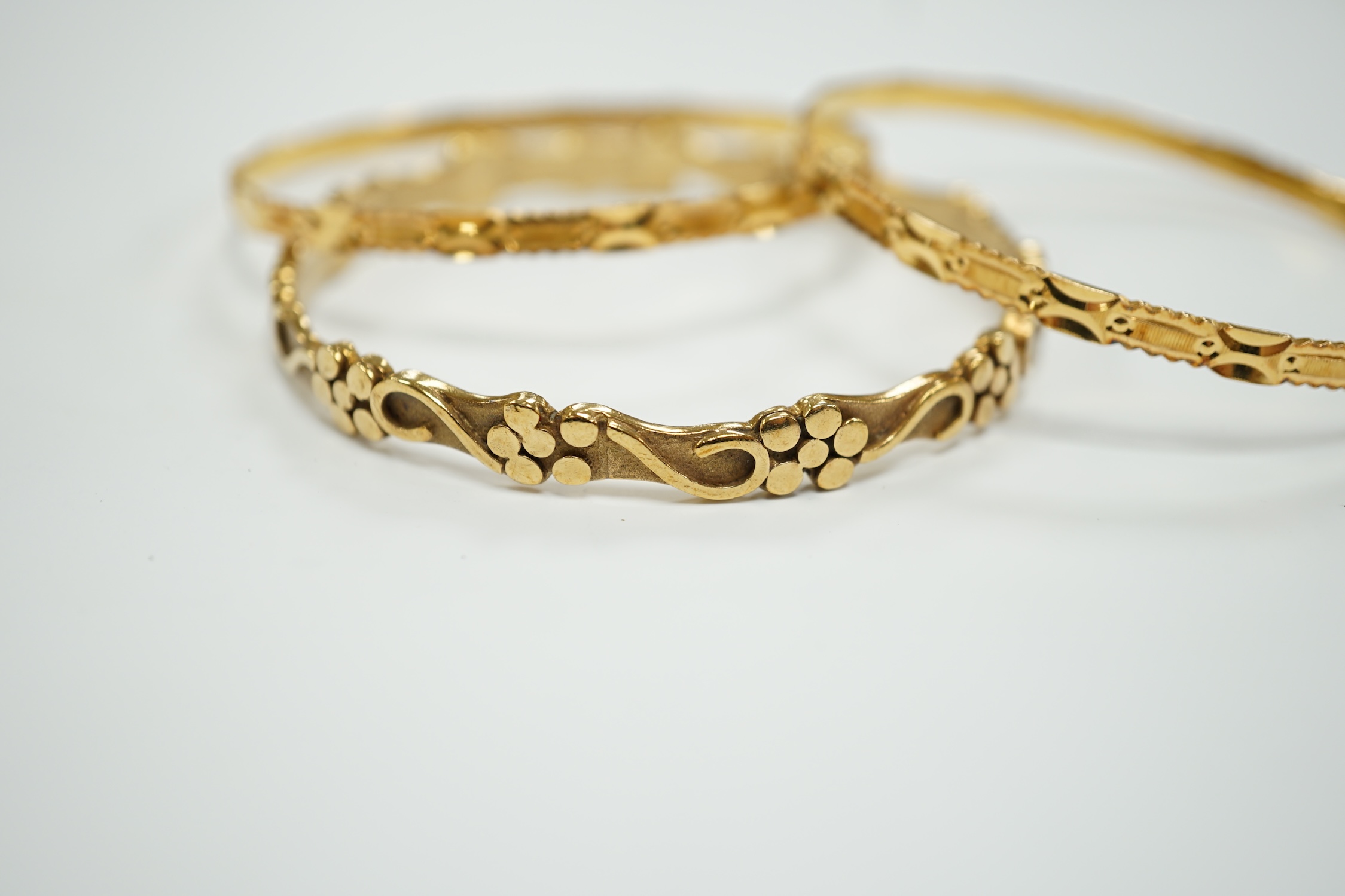 Two 22k bangles, 19.6 grams and a 9ct gold bangle, 20.6 grams.